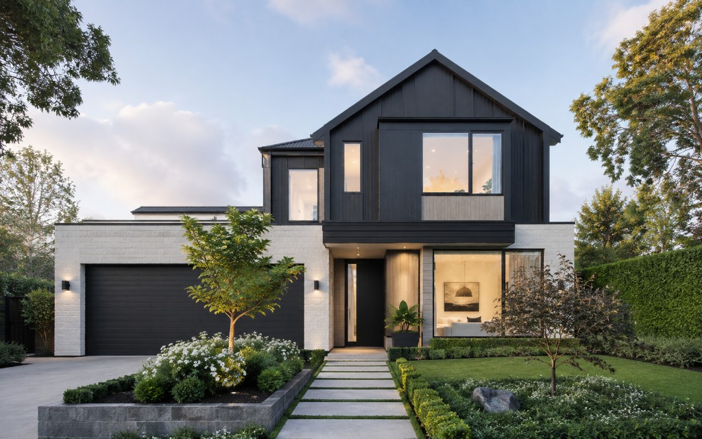 Modern home exterior at twilight with warm interior lighting for property marketing photography